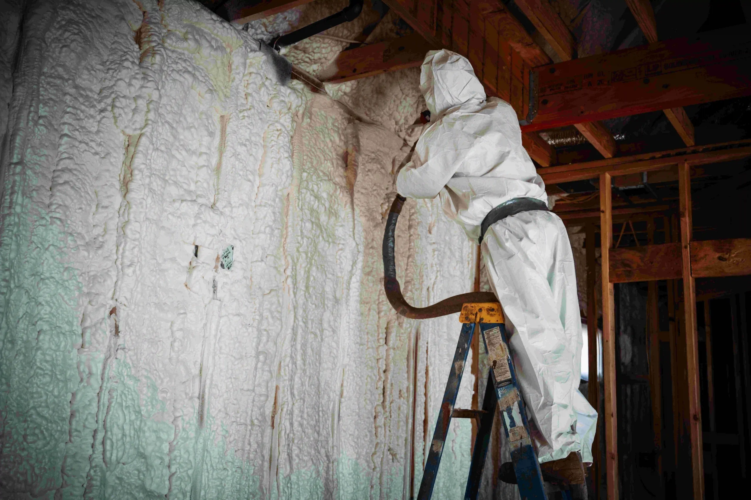The Cozy Penguin team installing spray foam insulation in a Central Pennsylvania home